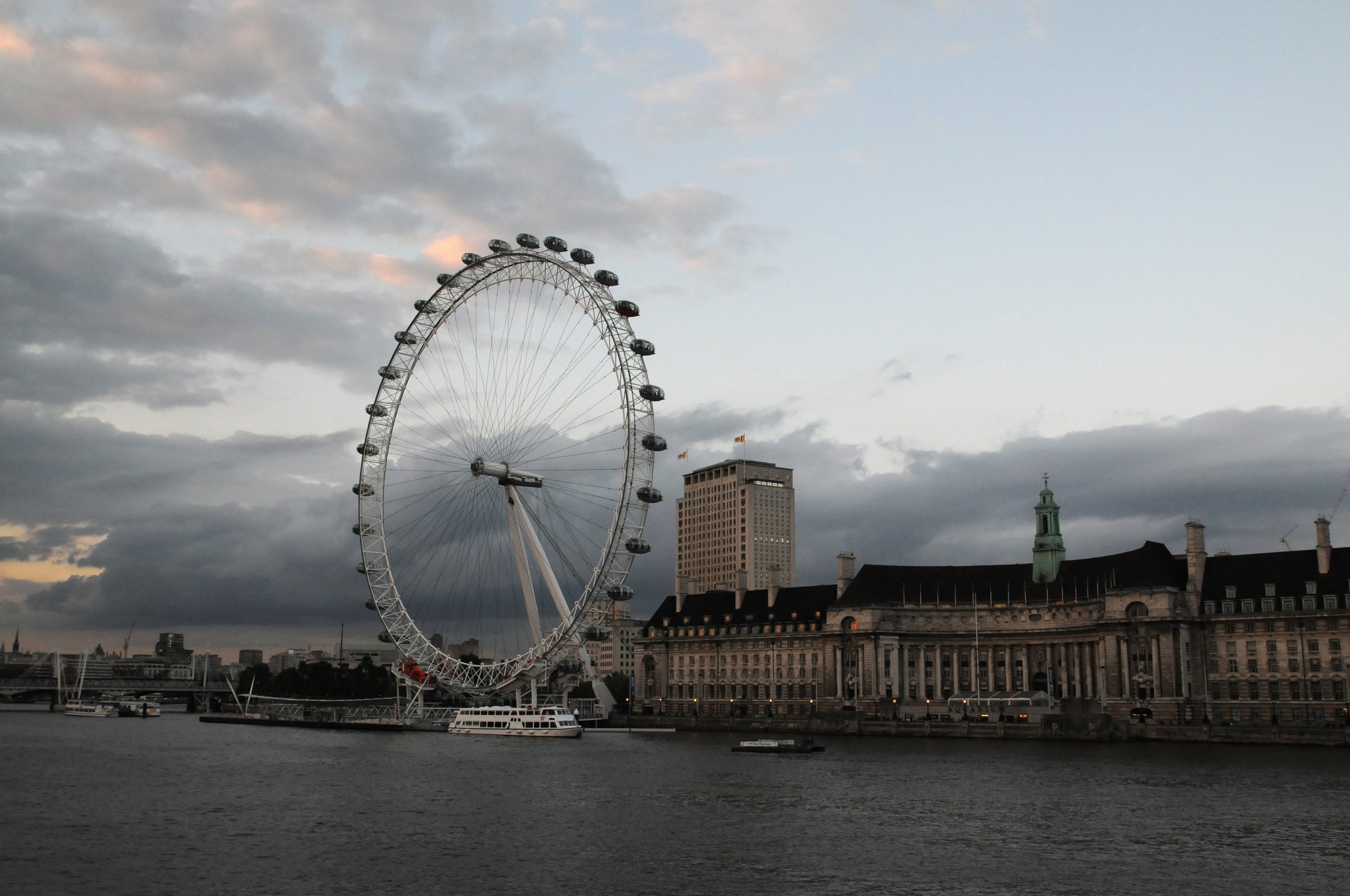 DSC_3415_2.jpg - Londýnské oko, anglicky London Eye (dřívější oficiální označení British Airways London Eye, někdy také označováno Millennium Wheel, tedy Kolo tisíciletí) je největší vyhlídkové kolo na světě od roku 1999. Je vysoké 135 m a stojí na západním okraji Jubilee Gardens na jižním nábřeží řeky Temže v Londýnském obvodu Lambeth mezi Westminsterským a Hungerfordským mostem. Sousedí s County Hall a na druhém břehu Temže stojí Ministerstvo obrany ve Westminsteru.